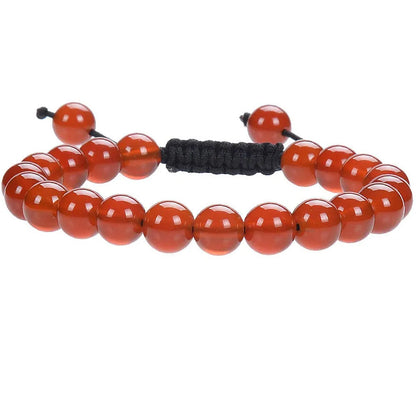 Close-up of a women's flat knot braided healing bracelet hand-woven with colourful gemstones.