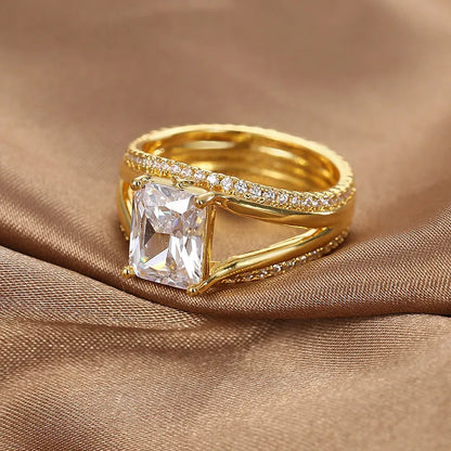 Gold electroplated geometric ring with a square zircon stone on a copper band.