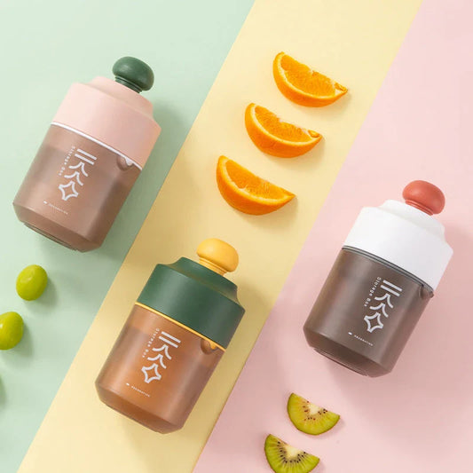 Premium manual citrus juicer in white, green, and pink colors, featuring a compact, portable design for effortless juice extraction