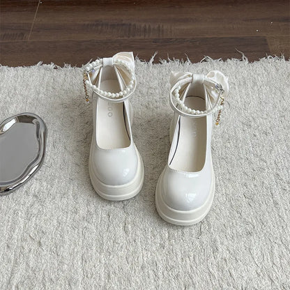 Women's beige chunky heel Mary Jane pumps with round toe and shallow mouth strap.
