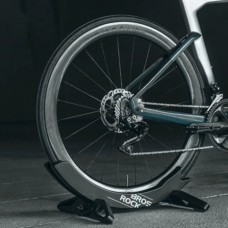 Black ABS plastic wall-mounted bicycle parking rack holder for road and mountain bikes.