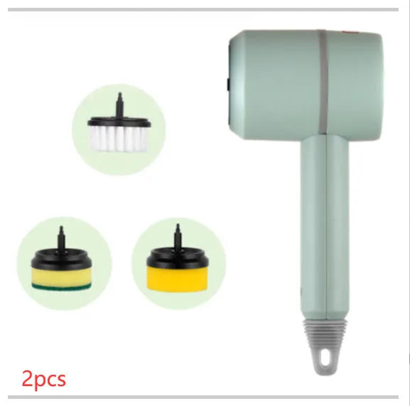 Green electric cleaning brush with scouring pad and brush heads on a kitchen worktop.