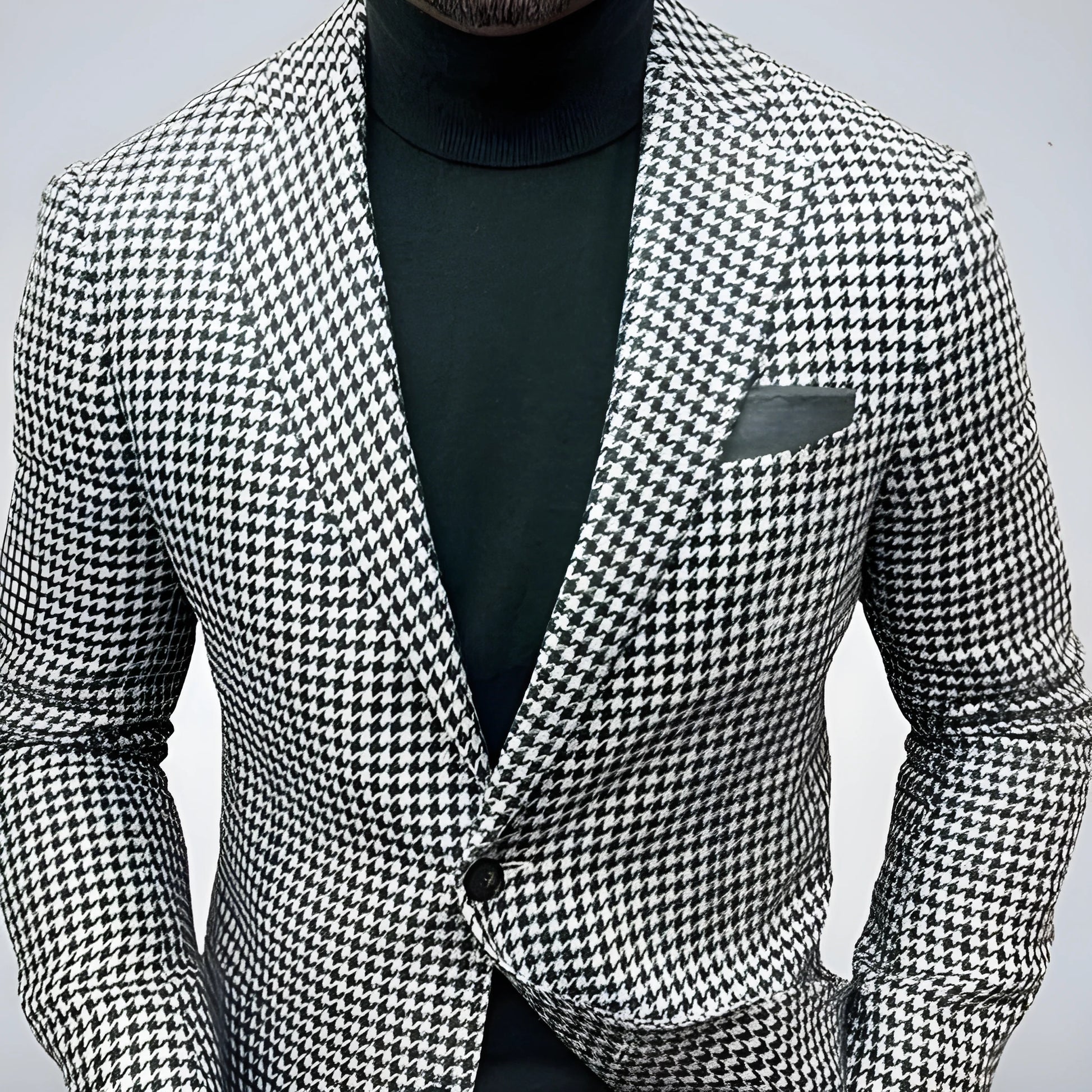 Men's slim fit two-button suit jacket with large top-stitch pockets in a polyester blend fabric.