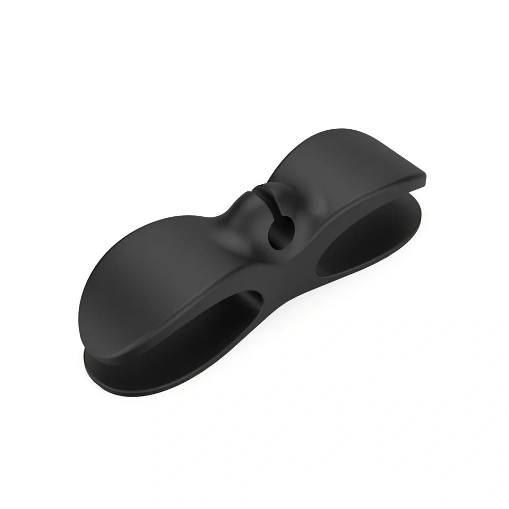 Black TPU cable organizer clips winding appliance cords on kitchen counter, 5cm size, non-marking adhesive for tidy management