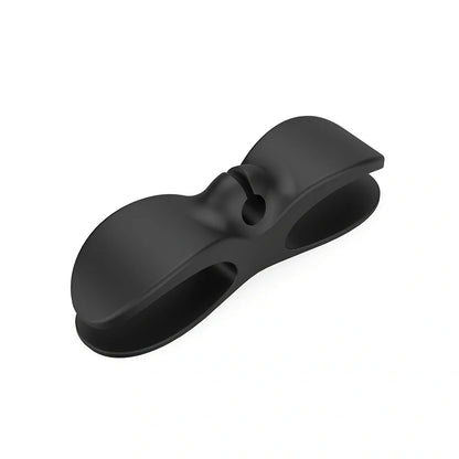 Black TPU cable organizer clips winding appliance cords on kitchen counter, 5cm size, non-marking adhesive for tidy management