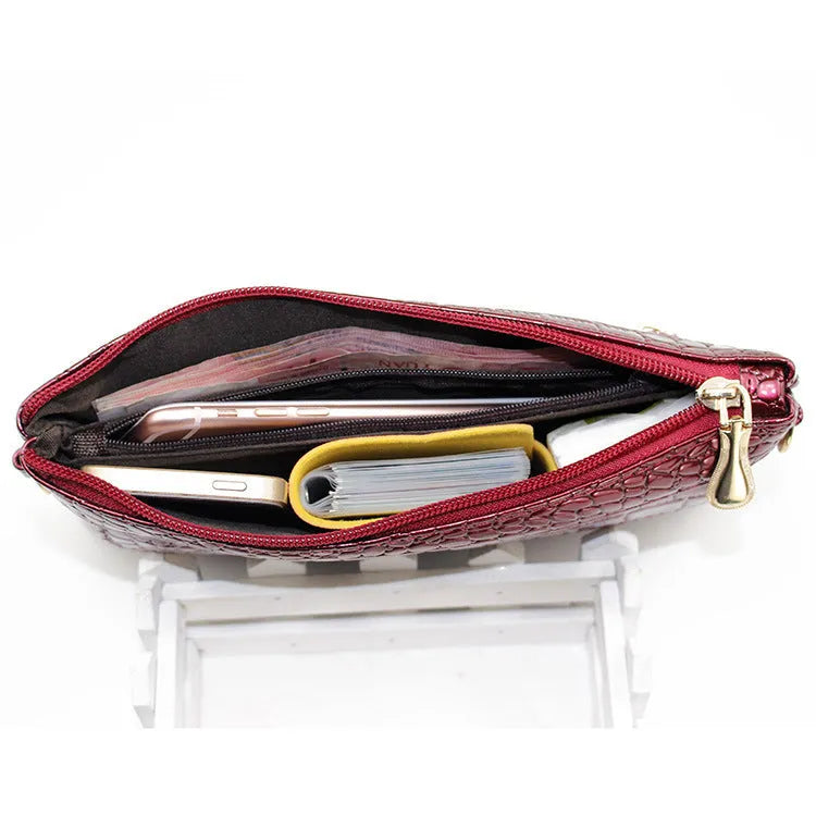 Women's black PU messenger bag showing horizontal square shape and shoulder strap