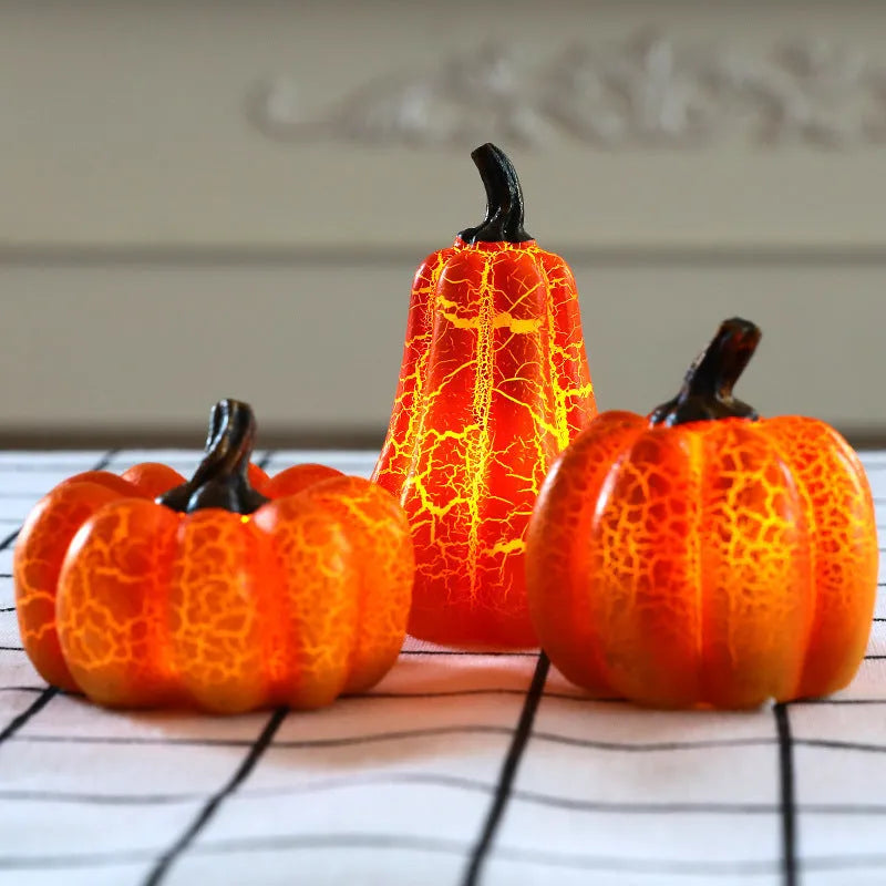 Set of three resin Halloween pumpkin lanterns with LED lights in long, medium, and short sizes.