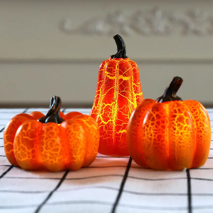 Set of three resin Halloween pumpkin lanterns with LED lights in long, medium, and short sizes.