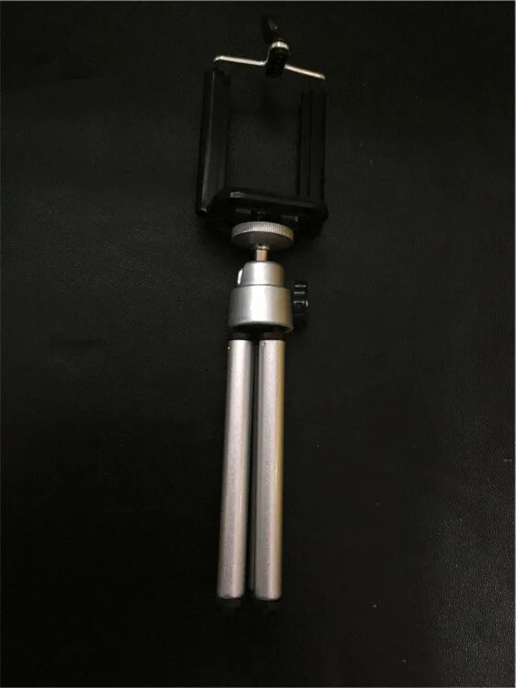 Silver adjustable desktop phone holder with two-section bracket on a wooden desk