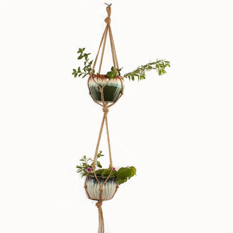Woven wire lattice plant holder with natural cotton rope, shown in a rustic style supporting a green plant.