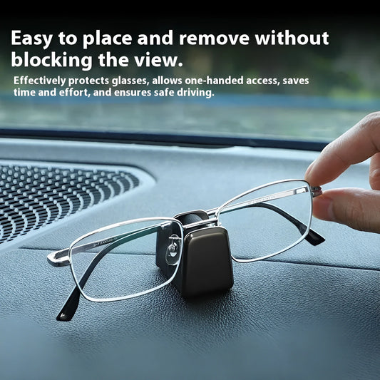 Green zinc alloy and leather glasses clip holder attached to a car dashboard, holding sunglasses.