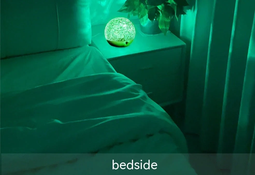 Spherical water ripple projector night light with touch controls creating colourful aurora patterns on wall