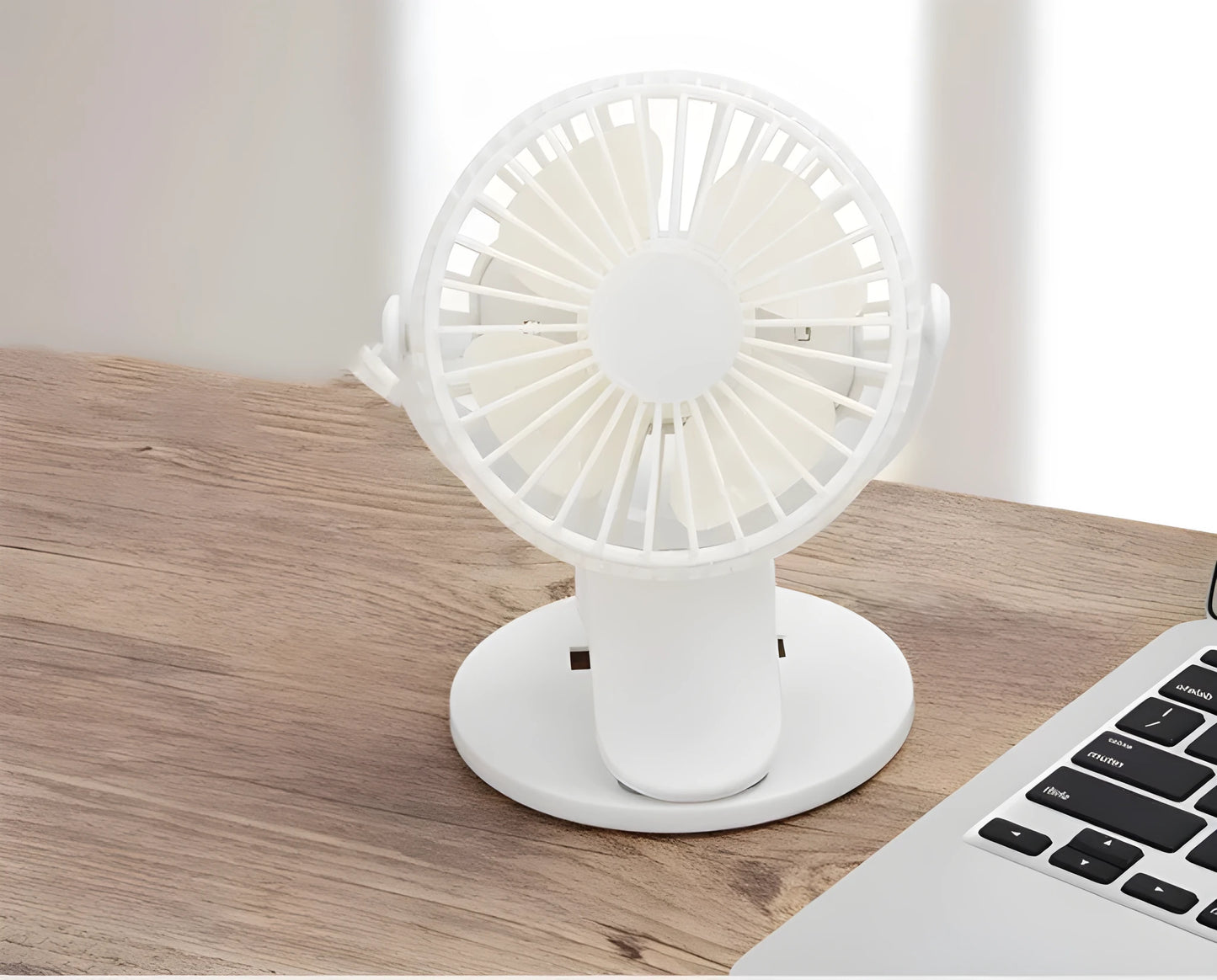 White USB rechargeable clip fan with plastic blades attached to a stroller handle.