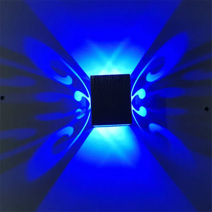 Modern aluminium butterfly-shaped LED wall lamp with remote control for colour changing.