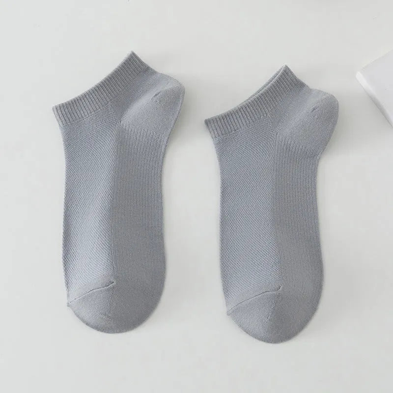 Pair of solid colour low-cut polyester boat socks for men, shown in one of six available colour options.