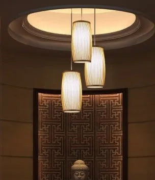 Hand-woven natural bamboo pendant lamp with open weave shade, hung from a black cord.