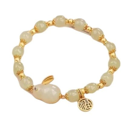 Green jade hare charm fu character bracelet with lily detail on black adjustable cord.