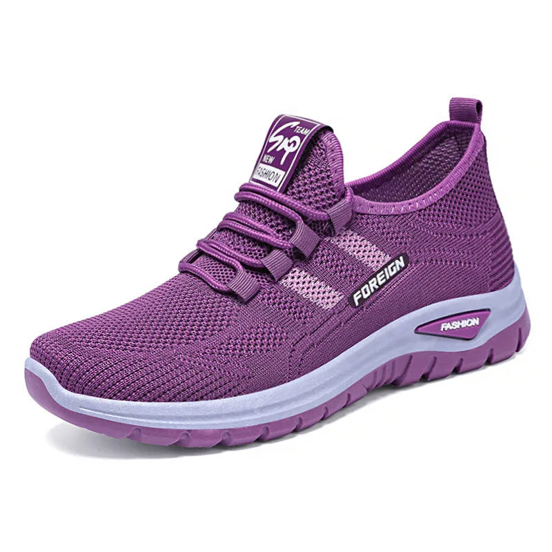 Low-top casual shoes with mesh upper and flat PVC sole in black, grey, purple, or red.