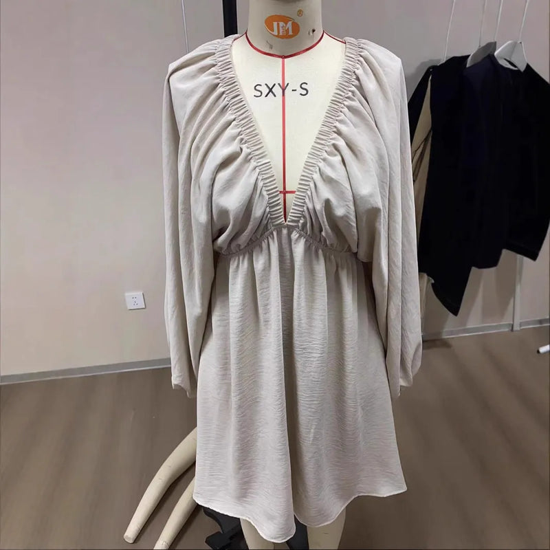Polyester V-neck long-sleeve dress with self-designed puff sleeves, flounced swing skirt, and mid waist in short length. Available in apricot, black, green, or white colour, with sizing options from S to XL for a temperament commute look.