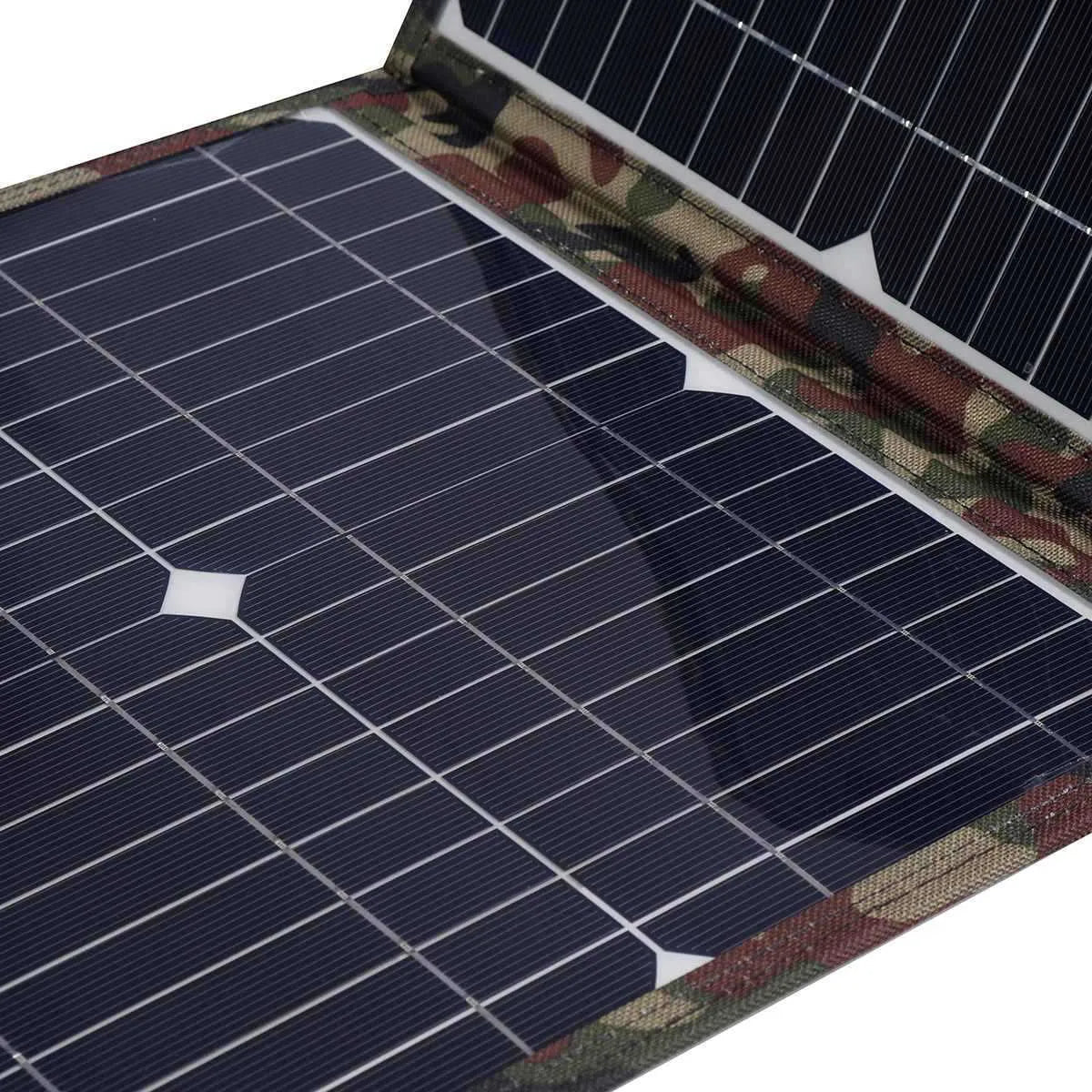 Black foldable portable solar panel unfolded showing solar cells, with included car charger and USB adapter.