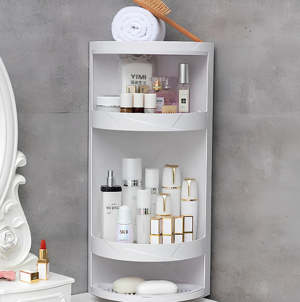 White triangle corner shelf with three tiers mounted in bathroom corner holding toiletries
