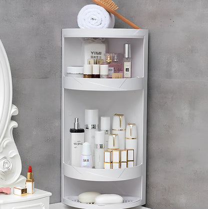 White triangle corner shelf with three tiers mounted in bathroom corner holding toiletries