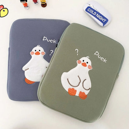 Blue tablet case with embroidered cartoon duck design showing zipper closure and cotton fabric texture