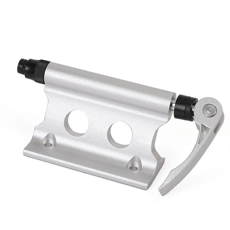 Silver metal quick-release clamp for attaching a bicycle front fork to a vehicle rack.