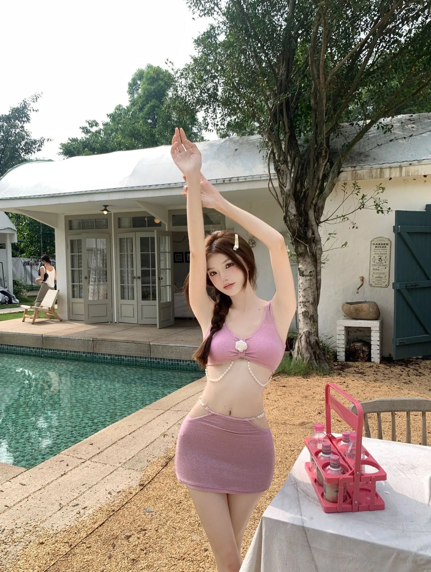 Pink and black three-piece bikini set with briefs style and sleeveless design for swimming.