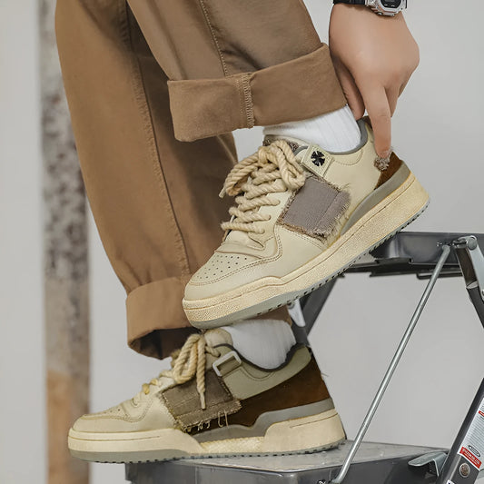 Beige low-top vintage-style skate shoes on a white background, showing round toe and lace-up front.