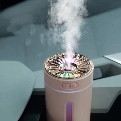 Black wireless car humidifier with colourful LED lights shown in vehicle cup holder