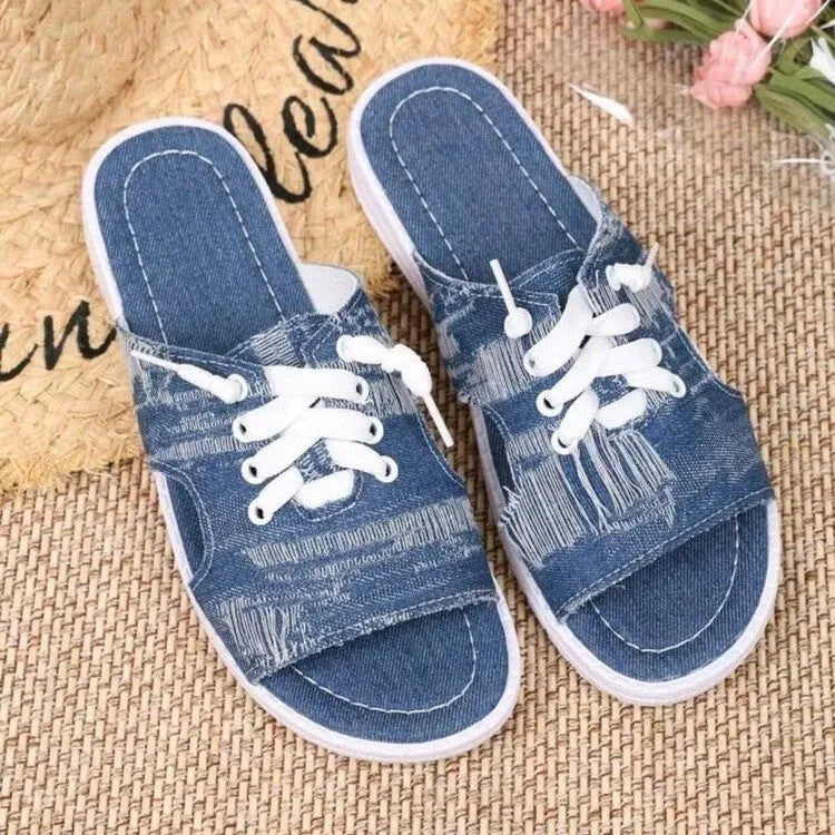 Blue Roman-style women's flat canvas slippers with a cloth upper and rubber sole.