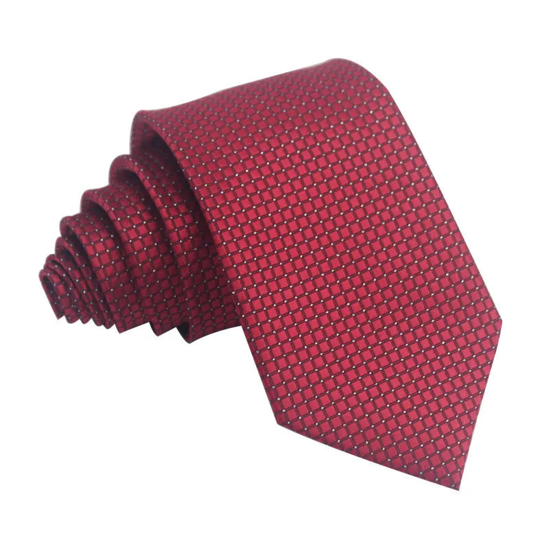 Close-up of a red and black striped jacquard weave tie with an arrow tip, showing texture.