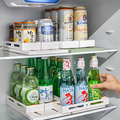 Pull-out spice rack installed under kitchen sink with spices organised in plastic drawer