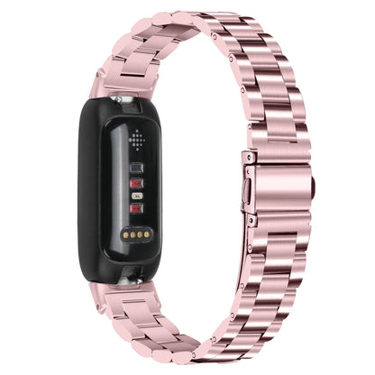 Three-bead stainless steel watch strap for Fitbit Inspire 3 in rose gold on a wrist