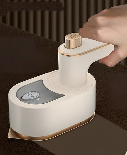 Green folding handheld garment steamer showing extended and collapsed positions with water tank visible