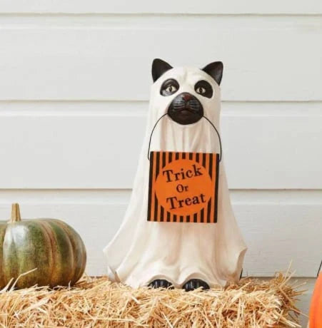 A ghostly dog figure carrying a large pumpkin candy bowl, an eerie and whimsical Halloween decoration for your home