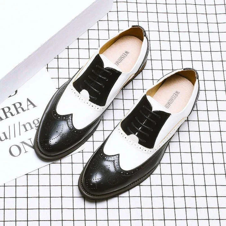 Elegant British-inspired men's business dress shoes with carved leather details and a sleek wedge heel