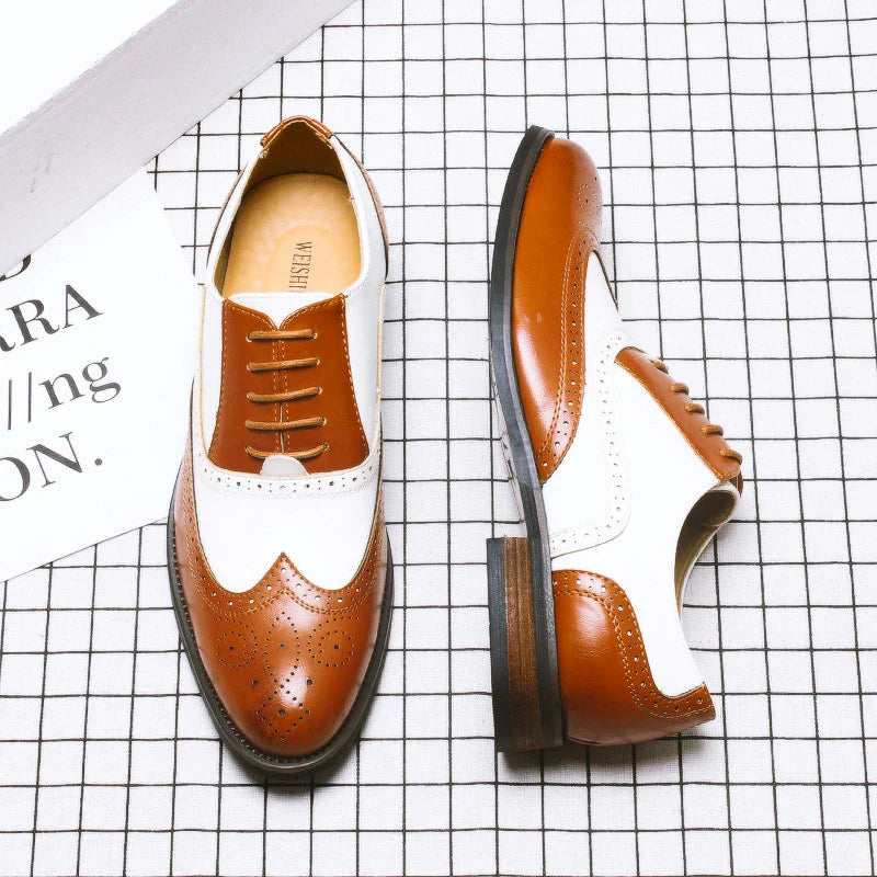 Elegant British-inspired men's business dress shoes with carved leather details and a sleek wedge heel