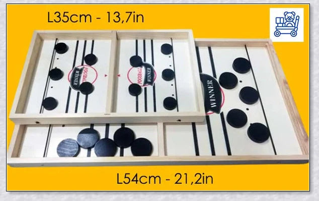 Two players competing in a wooden hockey game with pucks flying across the table