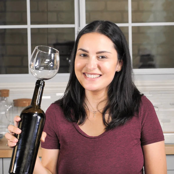 The Wine Glass Topper, a unique and elegant accessory that transforms any wine bottle into a personal wine glass, allowing for gentle aeration and enhanced flavor.