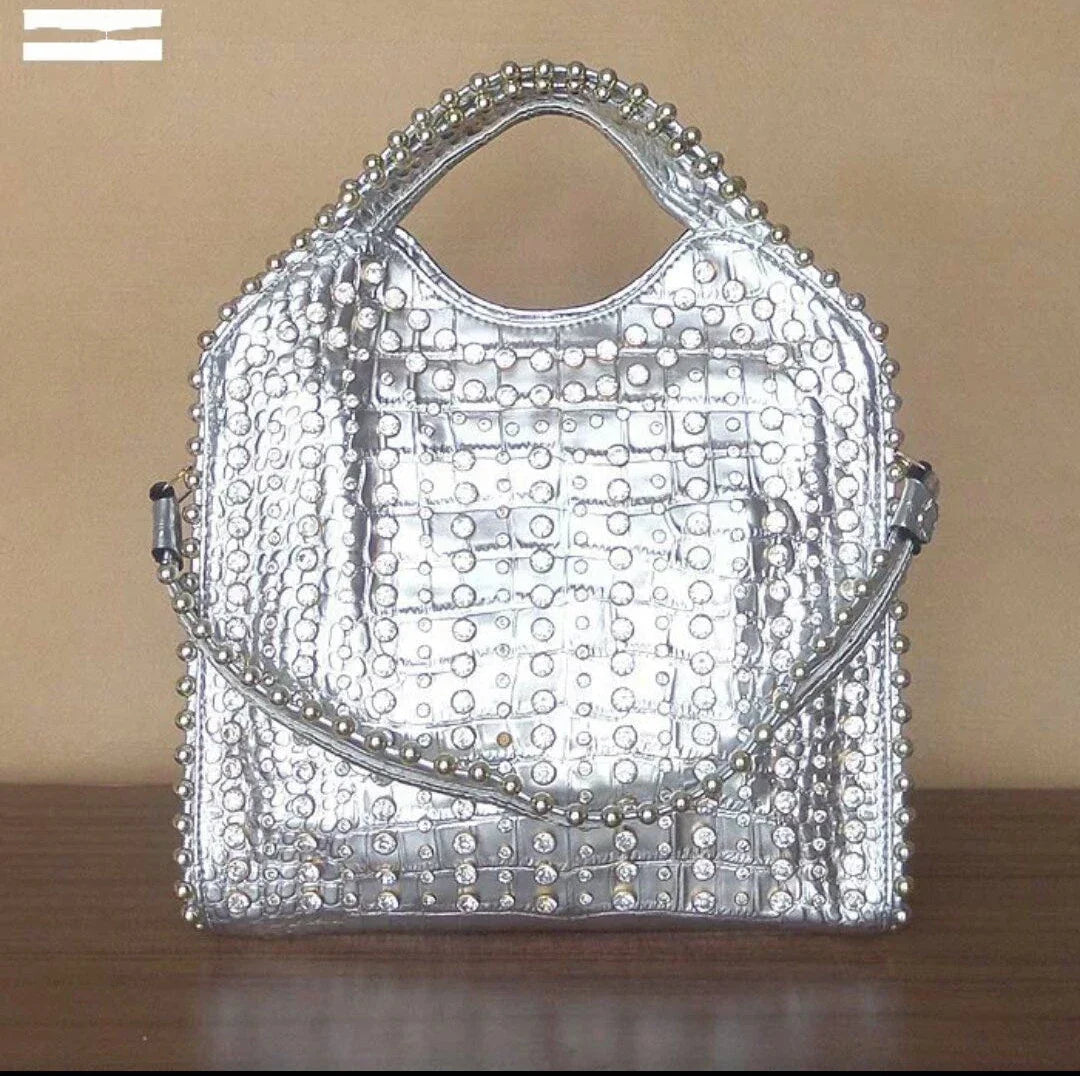 A glamorous messenger bag crafted with premium PU leather and adorned with sparkling diamond studs