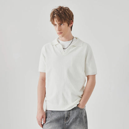 A man's solid-colour knitted polo t-shirt with short sleeves and a collar, shown in navy blue.