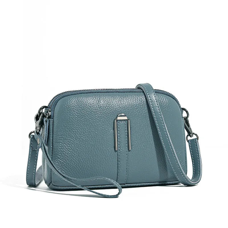 Minimalist top-grain leather crossbody bag in horizontal square shape with inner pockets, available in five colours