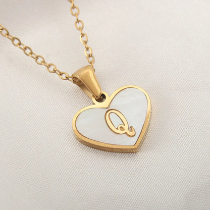 Gold-plated clavicle necklace with a white shell heart pendant, personalised with a letter from A to Z.