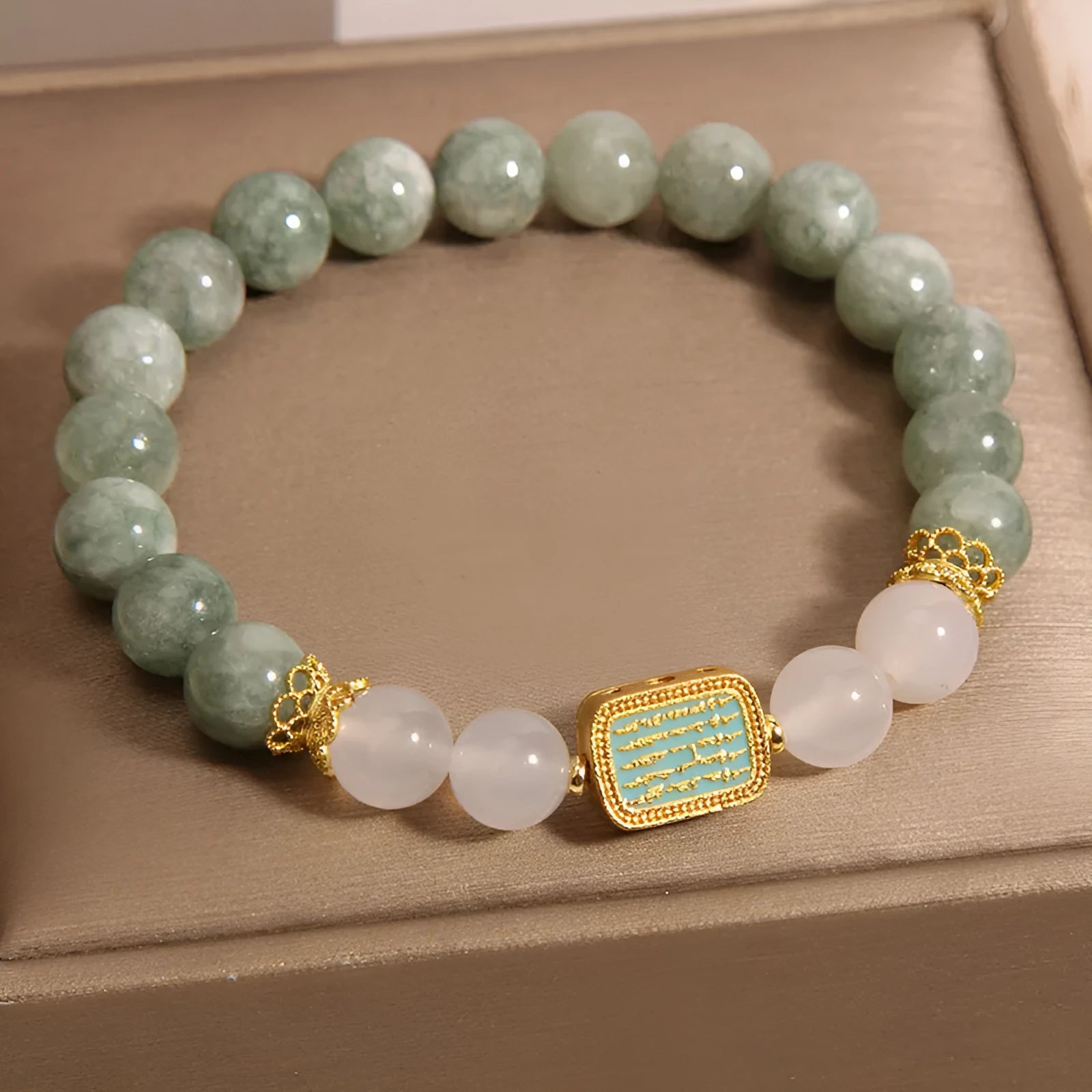 Women's bracelet with five oil green emerald crystal stones in a scripture charm design.