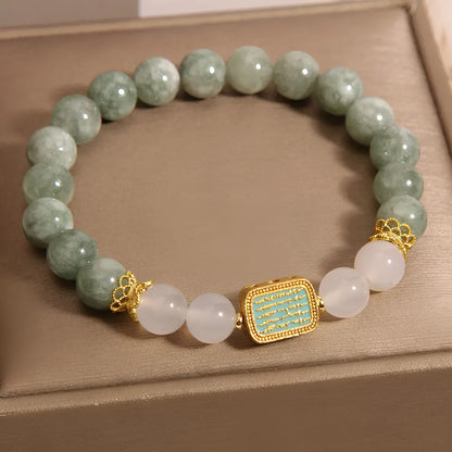 Women's bracelet with five oil green emerald crystal stones in a scripture charm design.