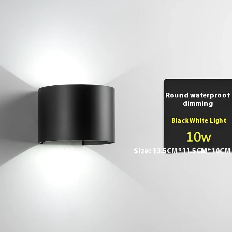 Black aluminium LED wall lamp with tempered glass shade mounted on white wall