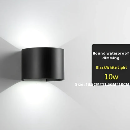 Black aluminium LED wall lamp with tempered glass shade mounted on white wall