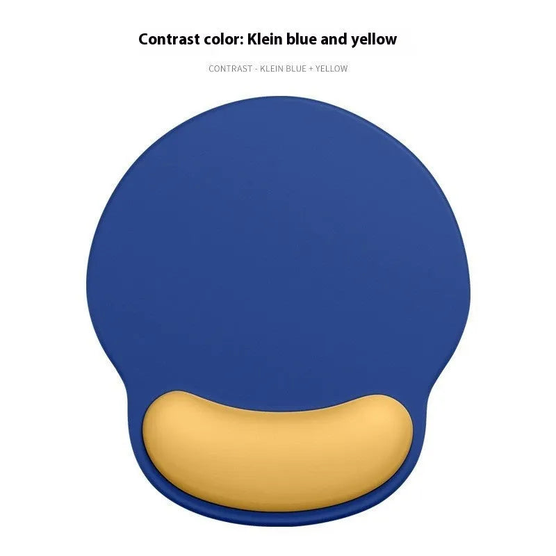 Silicone mouse mat with wristband in a gradient blue black colour pattern on a desk.